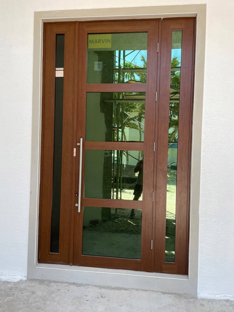 Newly installed wood door with glass panels